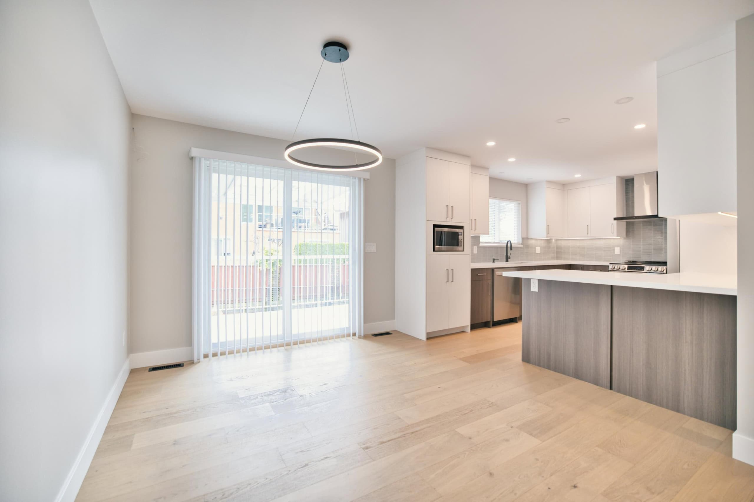 Bright modern kitchen interior with natural light, white cabinetry, and sleek appliances in a contemporary home for sale in BC.