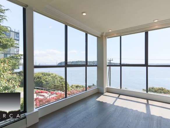 Stunning waterfront view from a modern condo, showcasing bright interiors and panoramic windows, perfect for luxury real estate buyers seeking Ocean views in British Columbia.