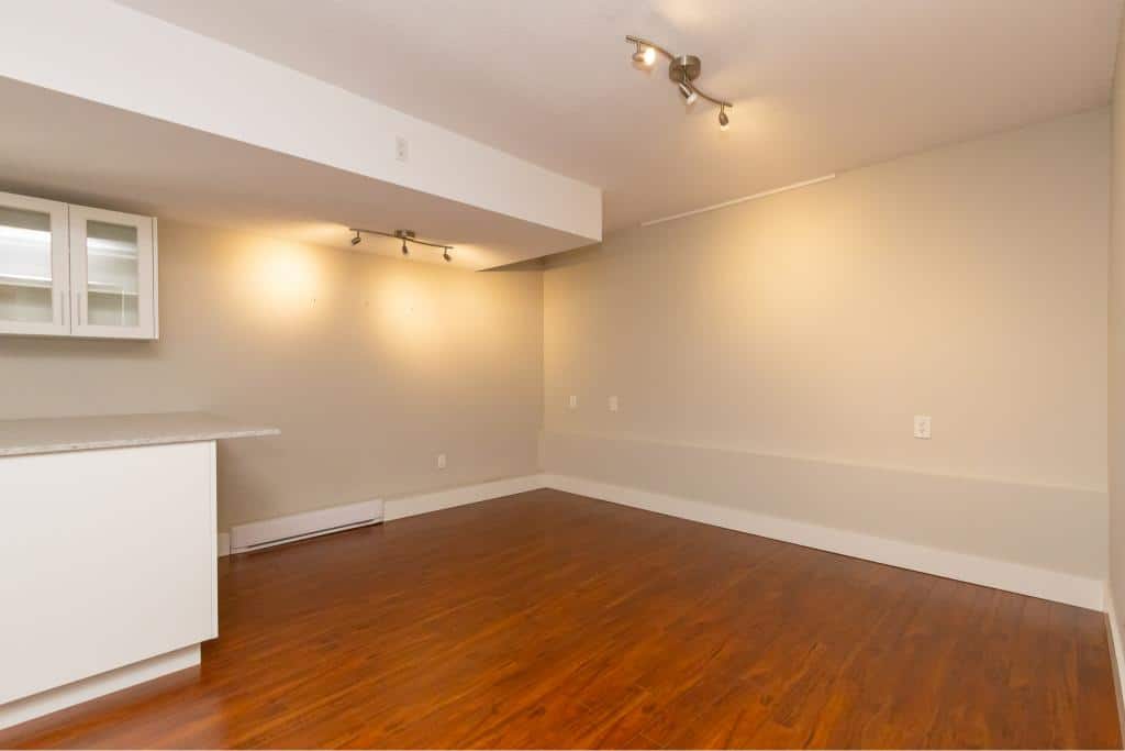 Spacious modern living room with hardwood floors and neutral walls, ideal for Ottawa real estate buyers seeking stylish homes.