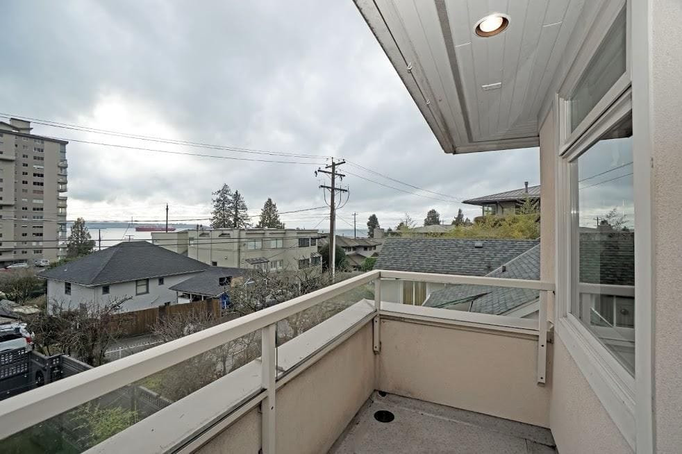 Spacious balcony with city views and privacy, ideal for relaxing or outdoor activities, featuring modern railing and surrounding residential neighbourhoods in Vancouver.