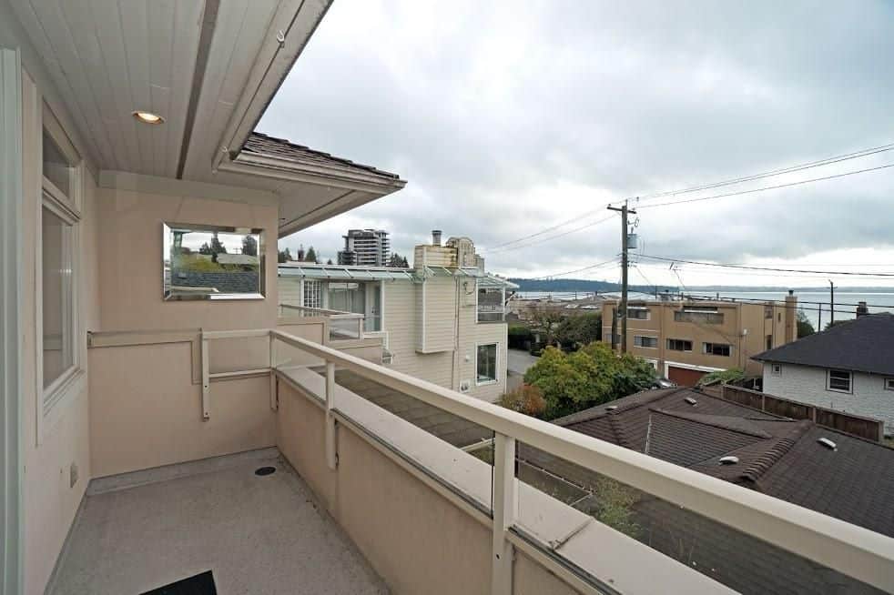 Bright balcony with ocean view in a coastal Vancouver home, ideal for relaxing or entertaining, showcasing contemporary architecture and scenic neighborhood surroundings in British Columbia.