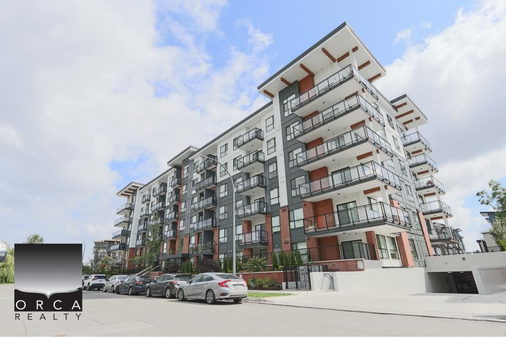 Contemporary multi-storey residential building with balconies and modern design, located in a vibrant urban setting. Perfect for real estate investment or new homebuyers in the Greater Toronto Area.