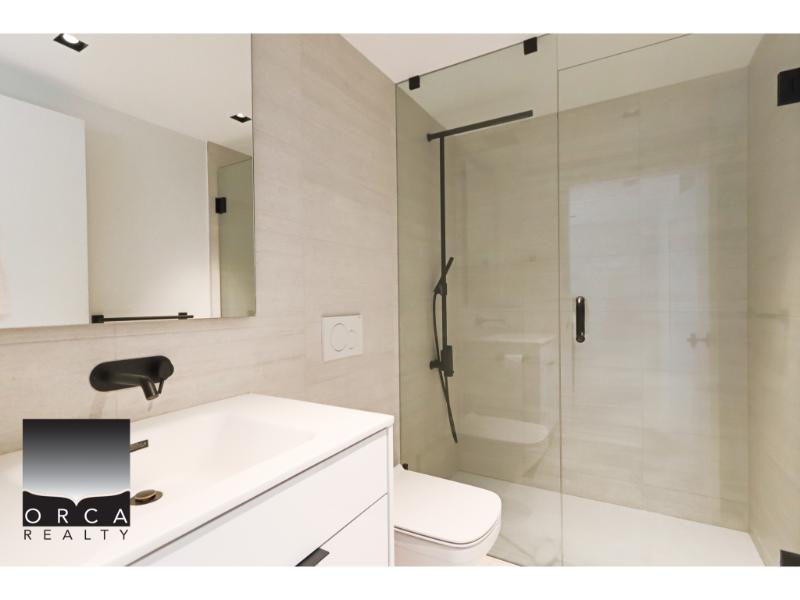 Modern bathroom with glass shower enclosure, stylish fixtures, and minimalist design, ideal for luxury Vancouver Island real estate.