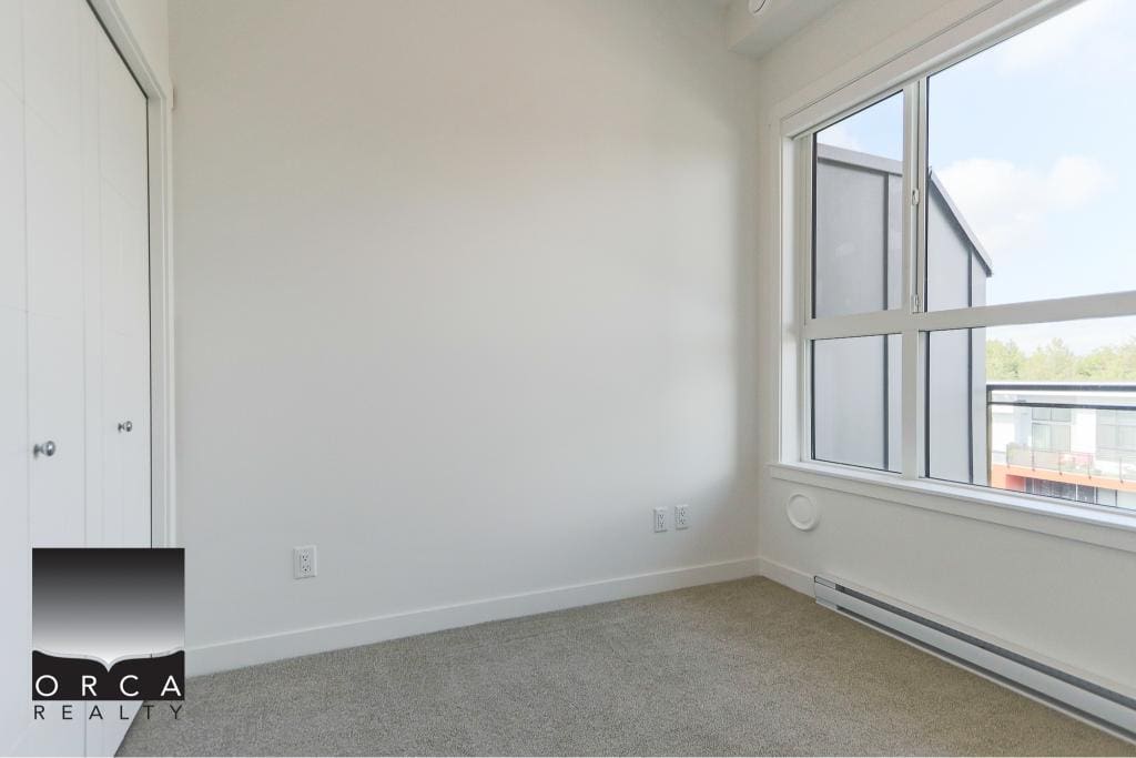 Bright empty bedroom with large window and closet, showcasing modern Vancouver Vancouver Island real estate, ideal for homebuyers seeking new condos or apartments in BC.