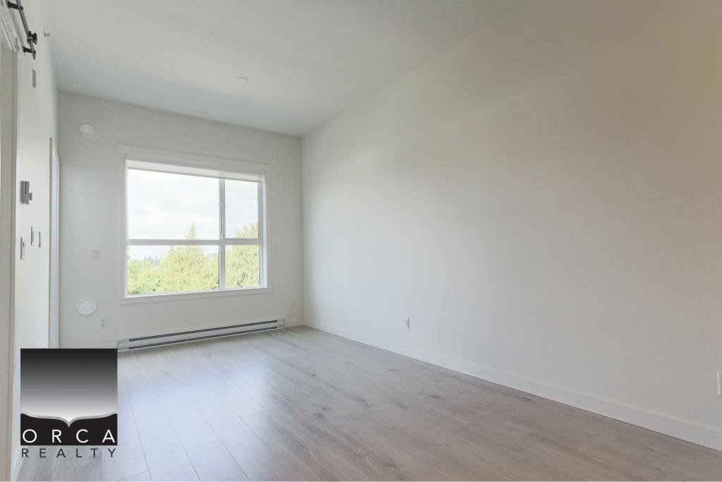 Bright empty room with large window and white walls, perfect for Vancouver Island real estate listings and home buyers searching for modern, spacious condos or homes for sale in Nanaimo.