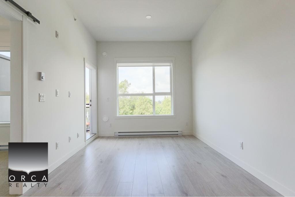Bright and modern empty living room with large window, white walls, light wood flooring, ideal for Vancouver real estate buyers seeking contemporary homes.