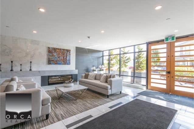 Modern real estate lobby with natural light, stylish furniture, and contemporary decor, emphasizing luxury home buying and selling services by Orca Realty Inc. in Vancouver.