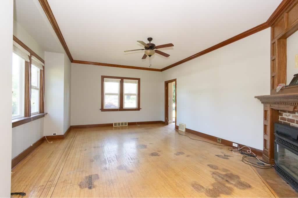 Spacious living room with hardwood floors, natural light, and decorative wood trim, perfect for family gatherings and entertaining.