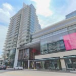 Modern mixed-use building in Vancouver featuring residential apartments and commercial retail spaces, showcasing contemporary architecture and urban living.