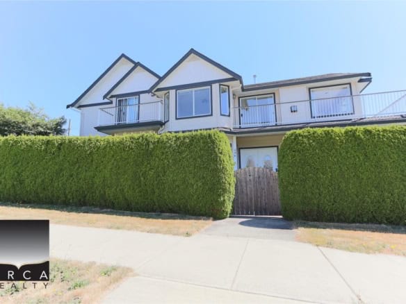 Modern family home with lush greenery and private gate - Orca Realty Inc. offers expert Vancouver Island real estate services.