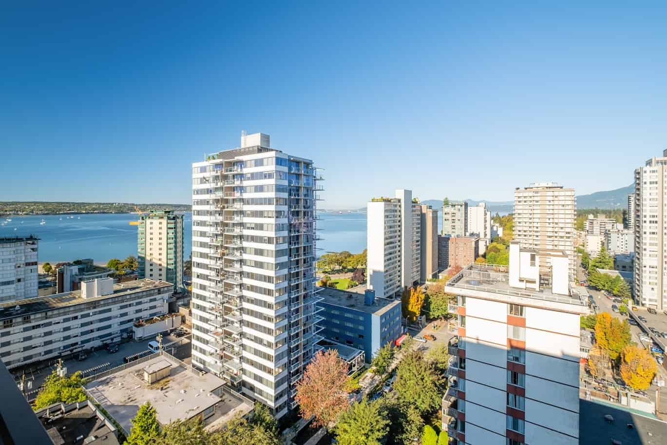 Modern high-rise waterfront apartment building in Victoria, BC with stunning views and luxury amenities. Prime real estate opportunity with scenic city and water landscape.