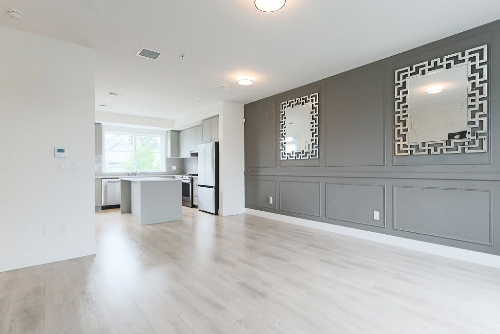 Bright open-concept living area with modern kitchen, ideal for Vancouver and Greater Toronto real estate markets. Sleek design perfect for buyers seeking contemporary homes.