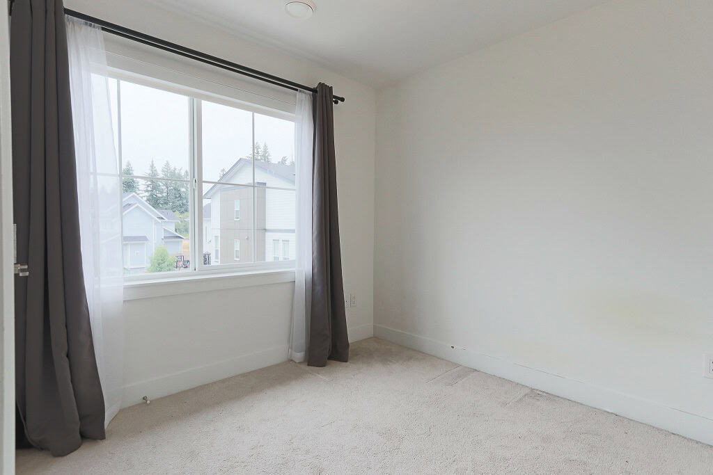 Bright modern bedroom with large window, natural light, and neutral decor, ideal for homebuyers seeking a spacious, move-in ready property in a family-friendly neighbourhood.