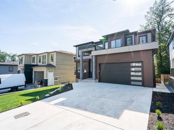 Modern contemporary home exterior with landscaped front yard and attached garage, showcasing premium real estate in a friendly neighbourhood.