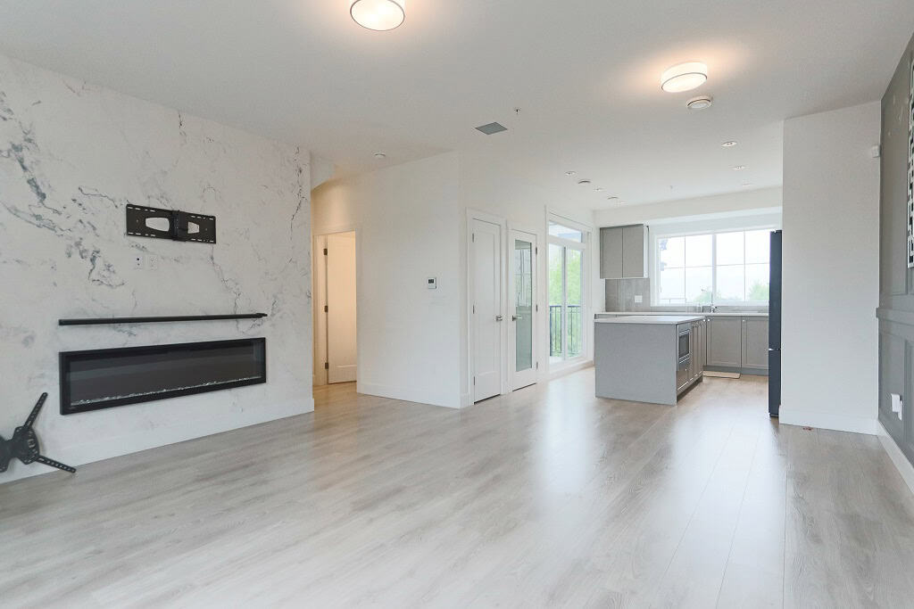 Spacious modern living room with open-concept kitchen in Vancouver, BC, featuring contemporary design, large windows, and hardwood flooring, ideal for real estate showcasing.