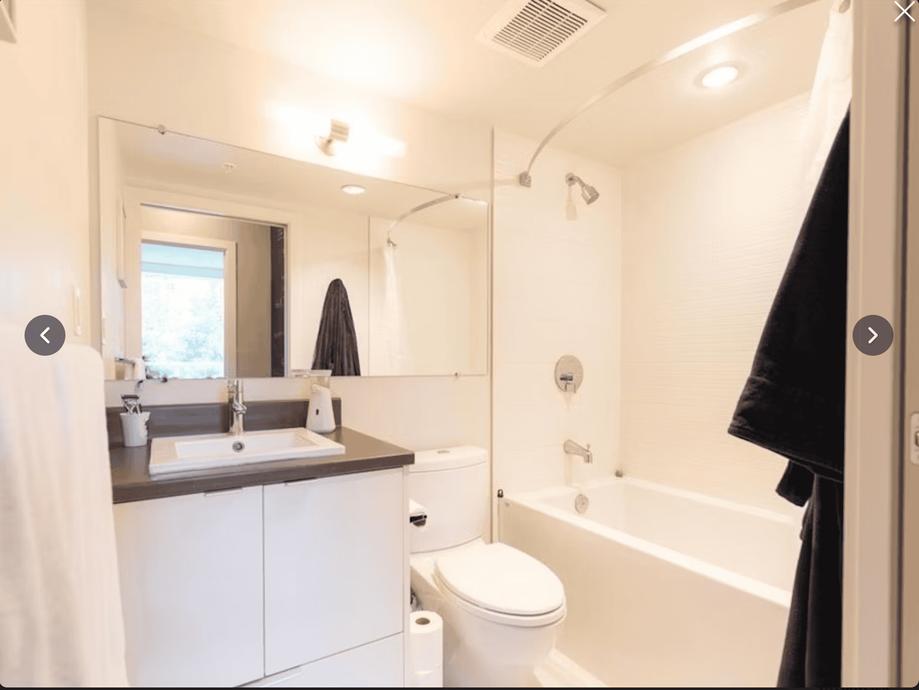 Modern bathroom with white fixtures, shower/tub combo, and contemporary decor at Orca Realty Inc. in BC. Perfect for home buyers and real estate listings in Vancouver and surrounding areas.