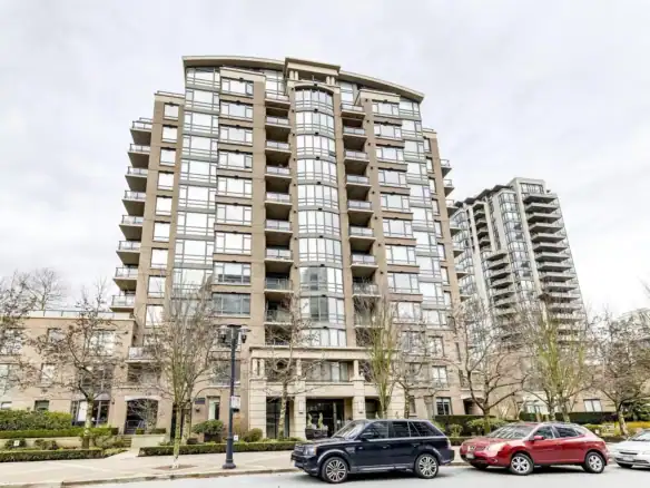 Elegant residential high-rise building in Vancouver with modern architecture and multiple balconies, offered by Orca Realty Inc., showcasing prime Vancouver real estate opportunities.