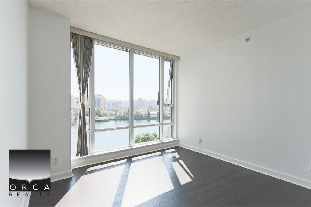 Bright modern apartment with large windows overlooking the water, ideal for Vancouver waterfront real estate investments and rentals.