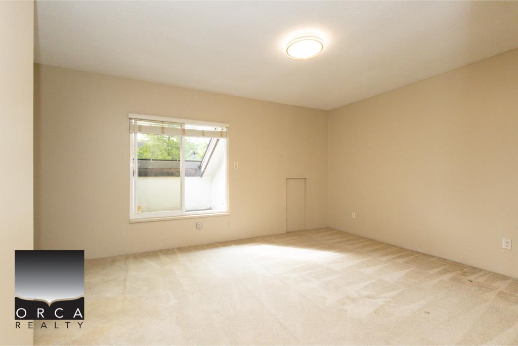 Bright spacious vacant living room with large window and neutral decor, ideal for real estate listings and showcasing properties in Vancouver.