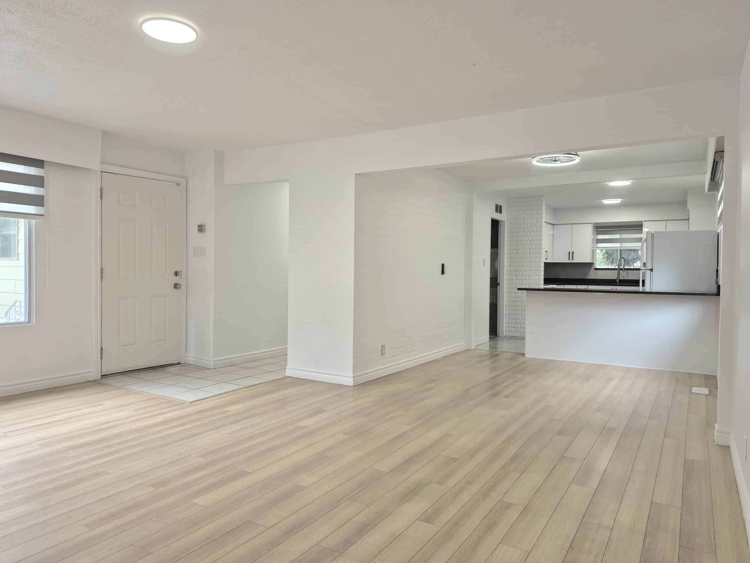 20250920_141053 Bright open-concept living room and kitchen in a modern home offered by Orca Realty Inc., showcasing spacious interior, natural light, and stylish design for Vancouver-area real estate.