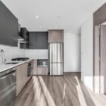 Contemporary kitchen with modern appliances, sleek cabinetry, and wood flooring, showcasing luxurious interior design perfect for Oceanview homes.