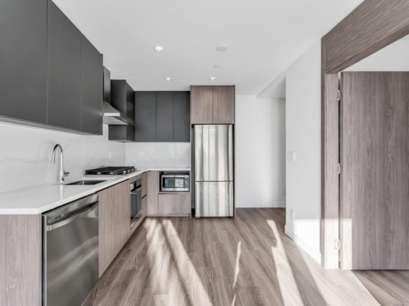 Contemporary kitchen with modern appliances, sleek cabinetry, and wood flooring, showcasing luxurious interior design perfect for Oceanview homes.