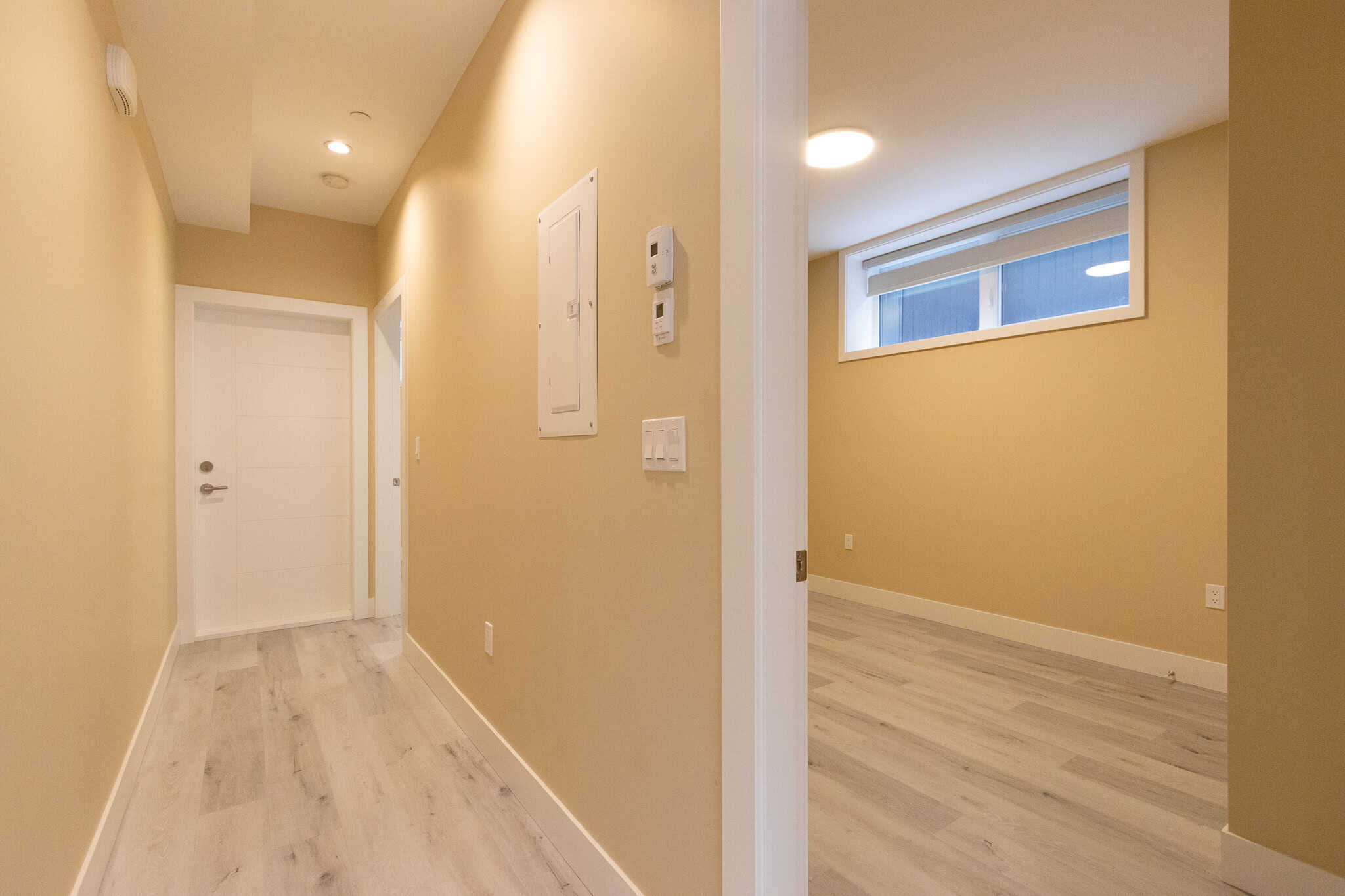 6 Bright modern hallway with light-colored walls and hardwood flooring, showcasing contemporary interior design, ideal for Vancouver real estate listings.