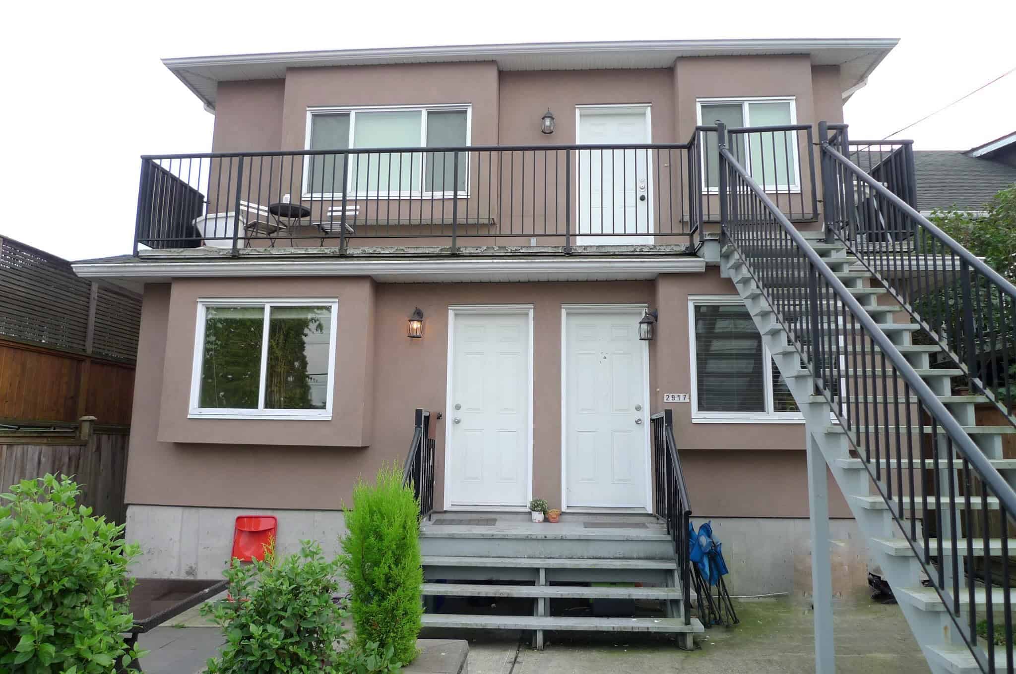 Modern two-storey family home with an inviting front porch, large windows, and a spacious upstairs balcony perfect for outdoor living, located in a friendly neighbourhood.