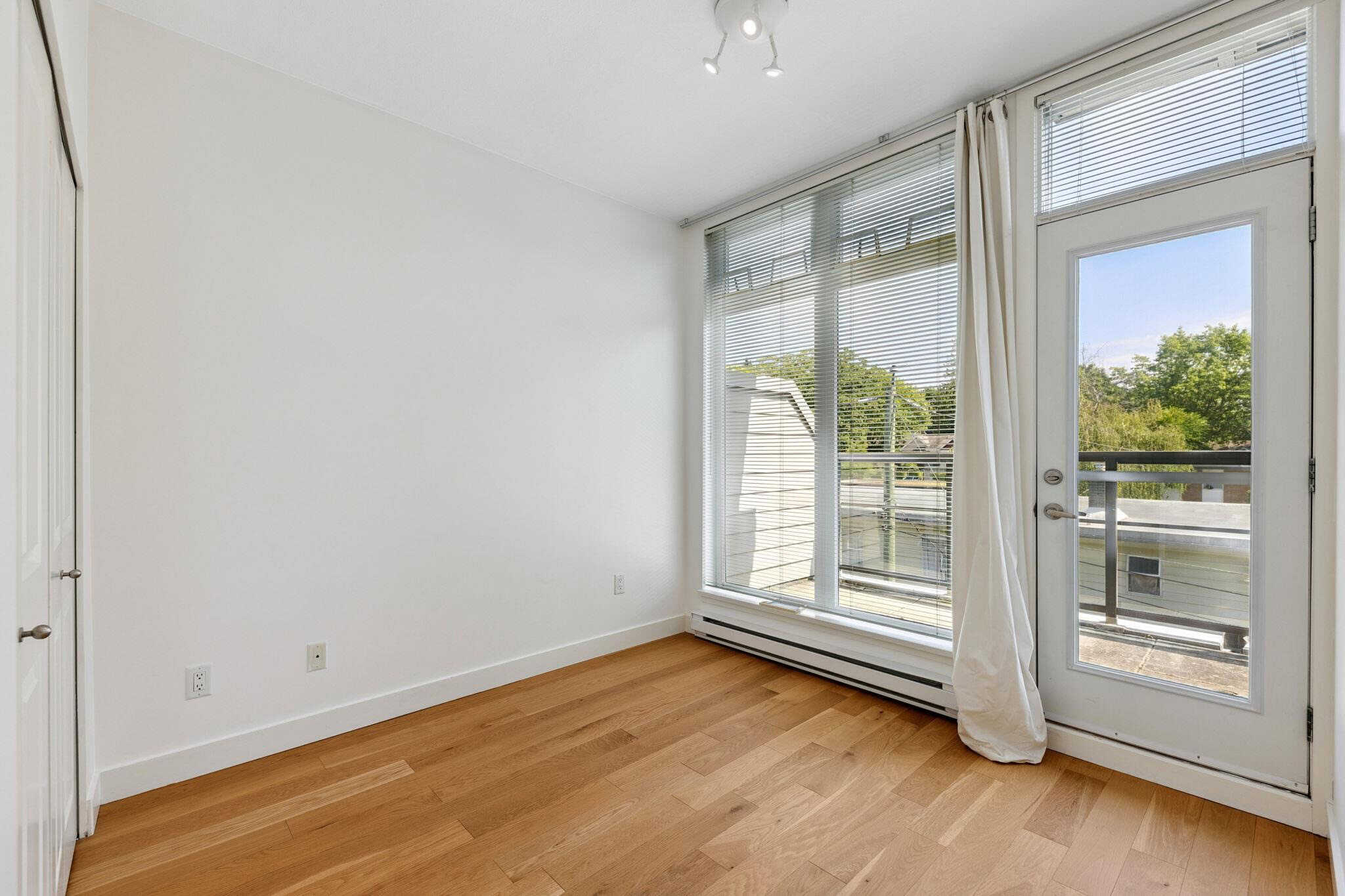 Bright modern interior with large windows, white walls, and hardwood floors, ideal for Vancouver Island real estate listings.