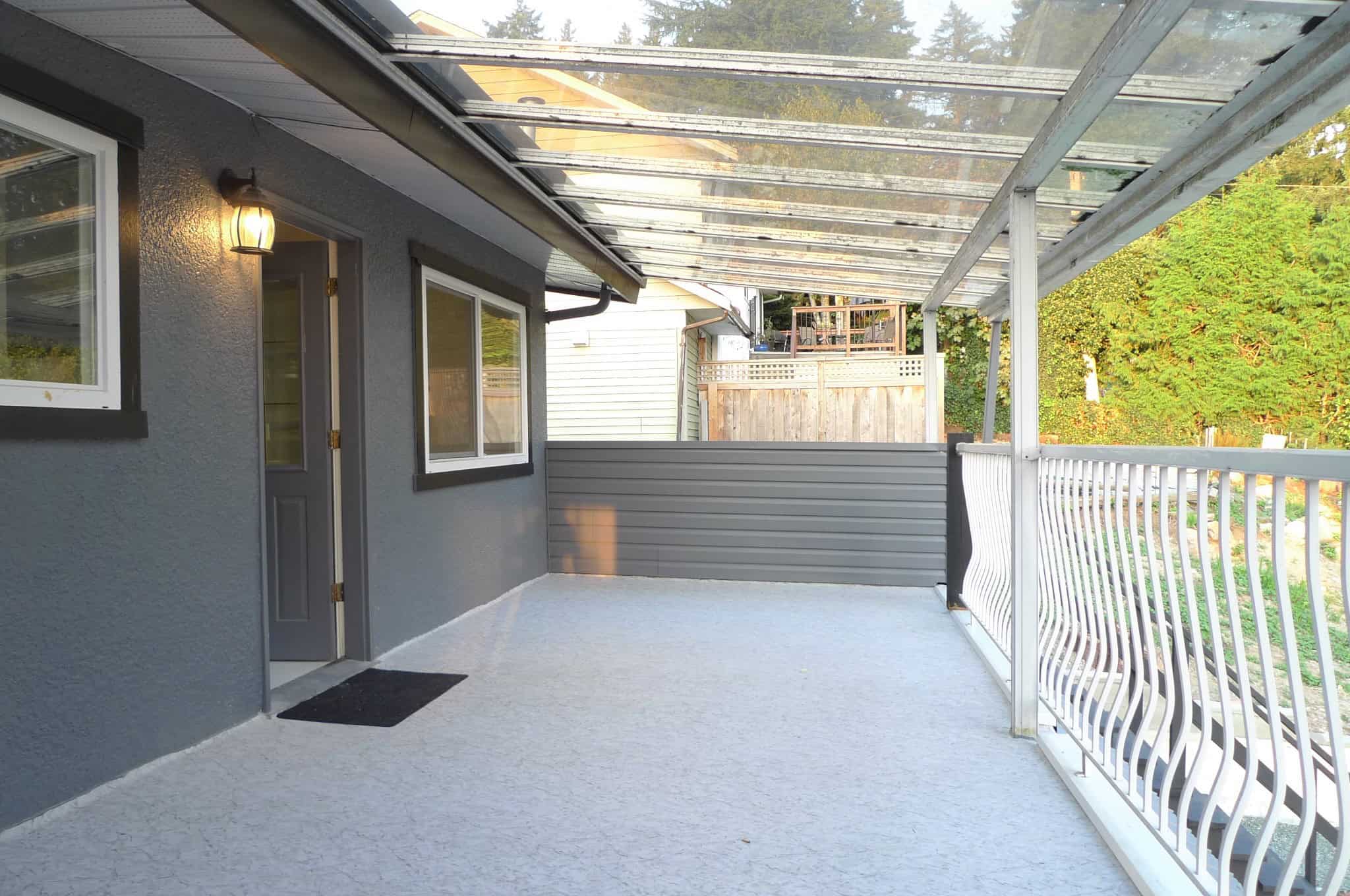 Balcony with a glass roof, outdoor space for relaxation, part of a modern home offered by Orca Realty Inc., showcasing real estate in Victoria, BC.