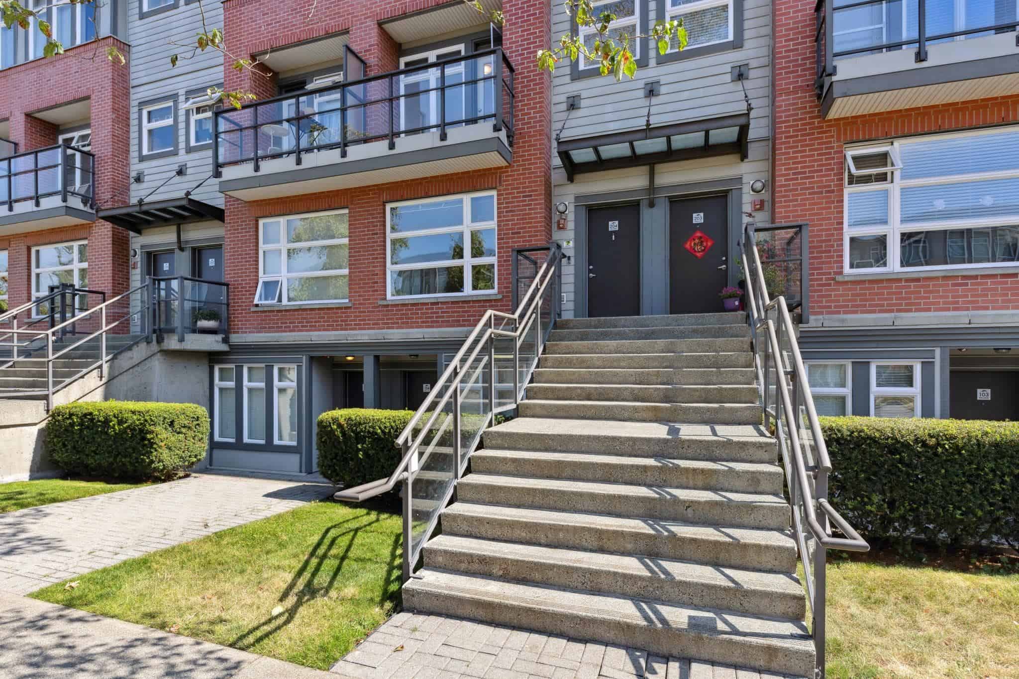 Modern multi-family residential building in Vancouver, BC, showcasing contemporary architecture, inviting entrance, and landscaped surroundings; ideal for real estate investment opportunities.