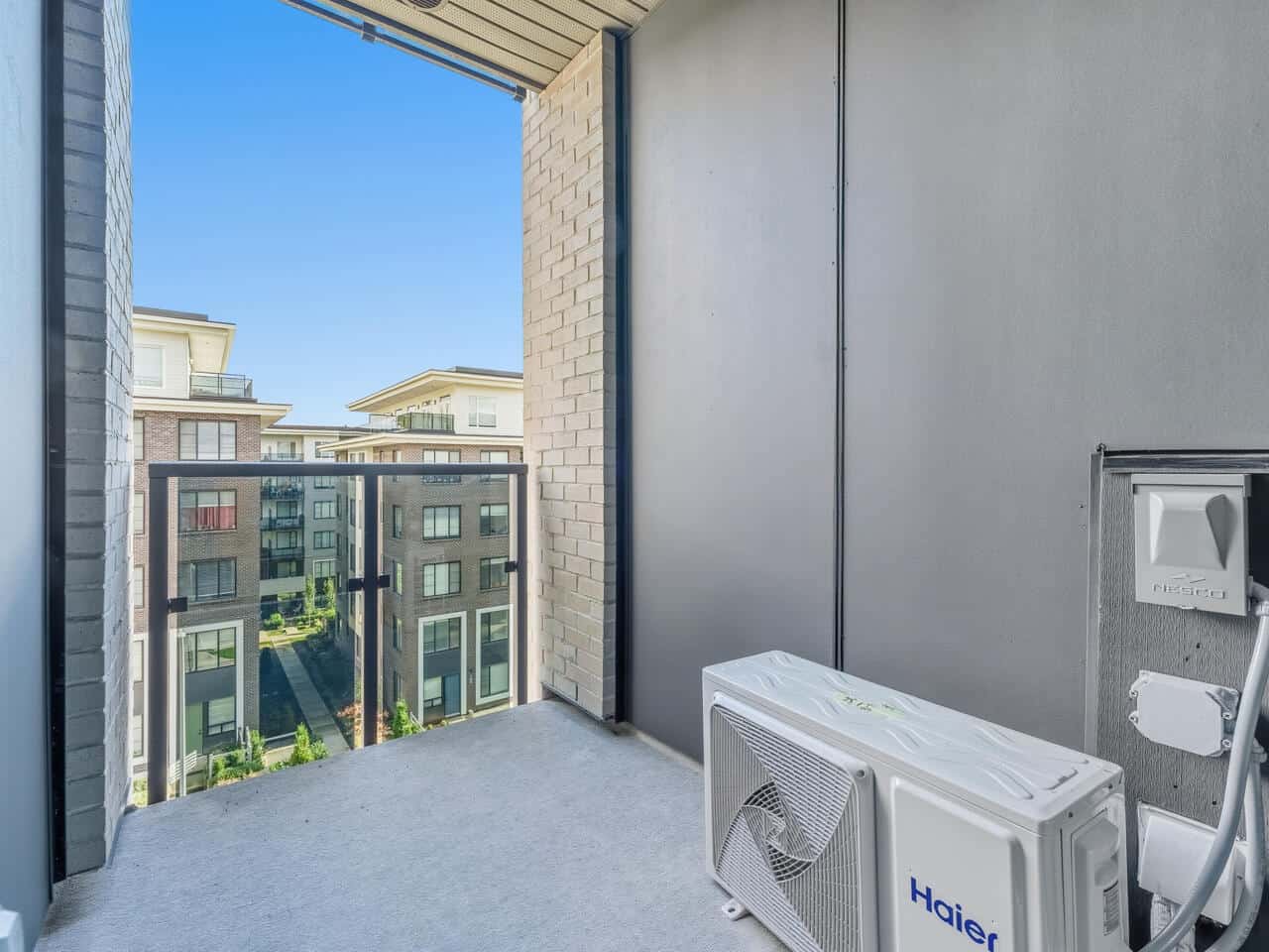Modern apartment balcony with city views in Vancouver, BC, featuring fresh air, outdoor space, and a climate-controlled environment, ideal for urban living and real estate investment, freshly renovated.