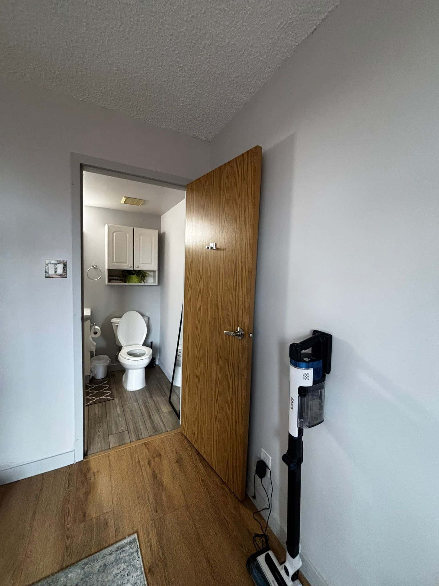 Bright interior shot with view into a bathroom showcasing modern home features and clean decor, ideal for Vancouver real estate listings.