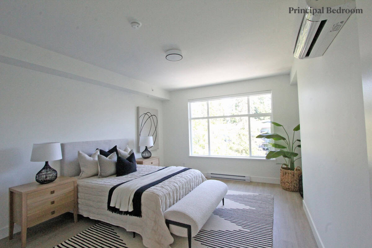 Modern principal bedroom with minimalist decor, large window, and stylish furniture; ideal for Vancouver real estate listings.
