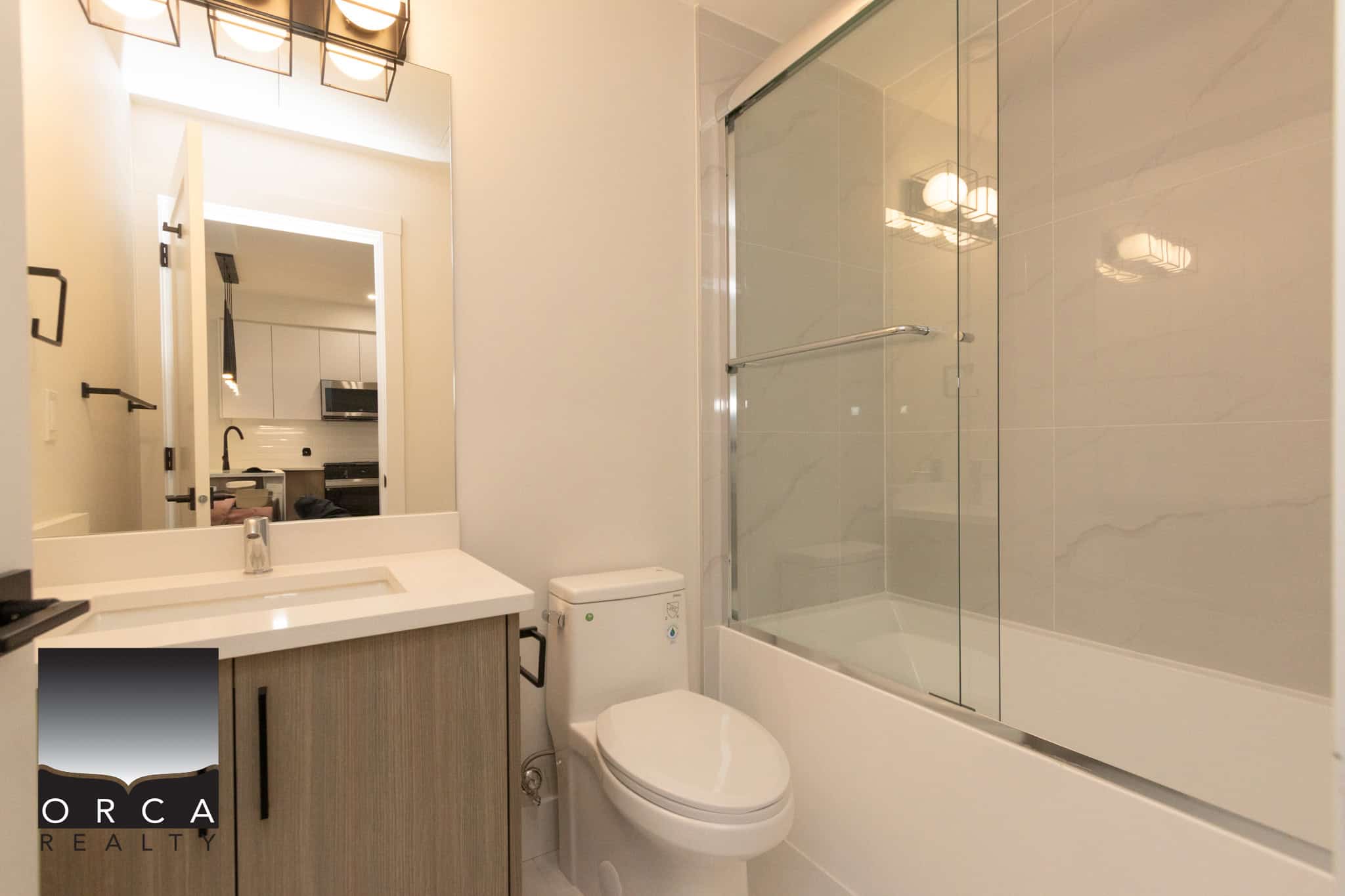 Contemporary bathroom with modern fixtures, glass shower enclosure, and sleek vanity, perfect for stylish homes in BC. Ideal for real estate listings showcasing Toronto or Vancouver properties.