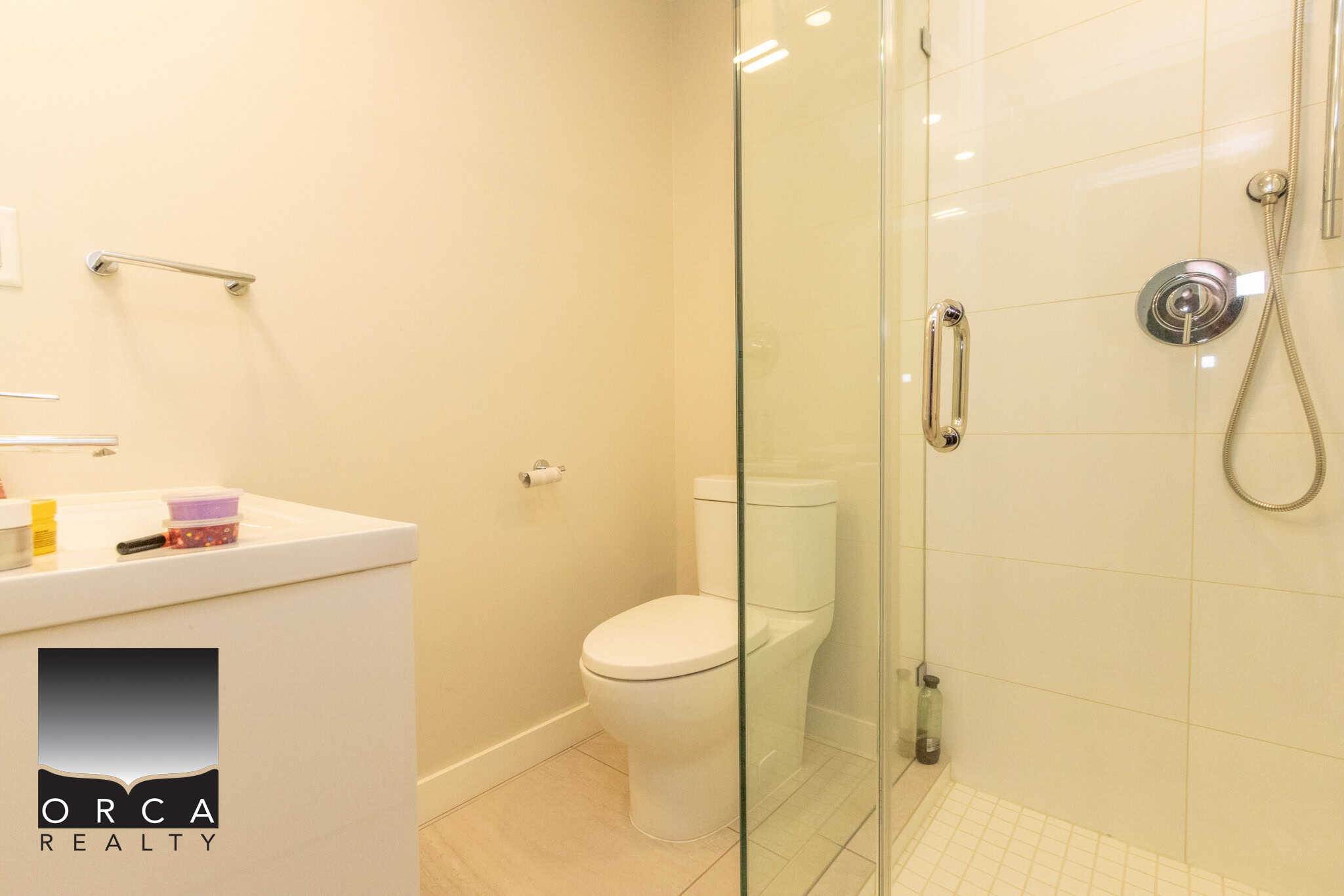 Bright and clean bathroom featuring a glass-enclosed shower, modern fixtures, and neutral tones, perfect for the property at 103-649 3rd Street East, North Vancouver.