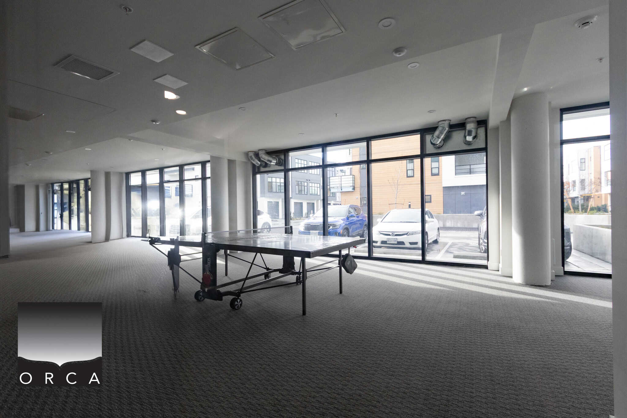 Spacious commercial office space with large floor-to-ceiling windows, modern interior design, and ample natural light, perfect for businesses seeking an elegant and flexible workspace in Victoria.