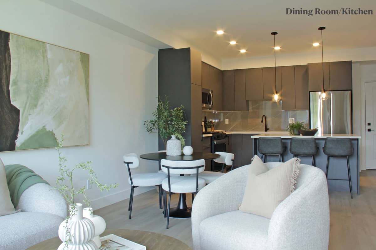 Modern Vancouver-style kitchen and living room in a stylish condo overview, showcasing open-concept design with sleek cabinetry, contemporary furniture, and high-end finishes for Vancouver real estate listings.