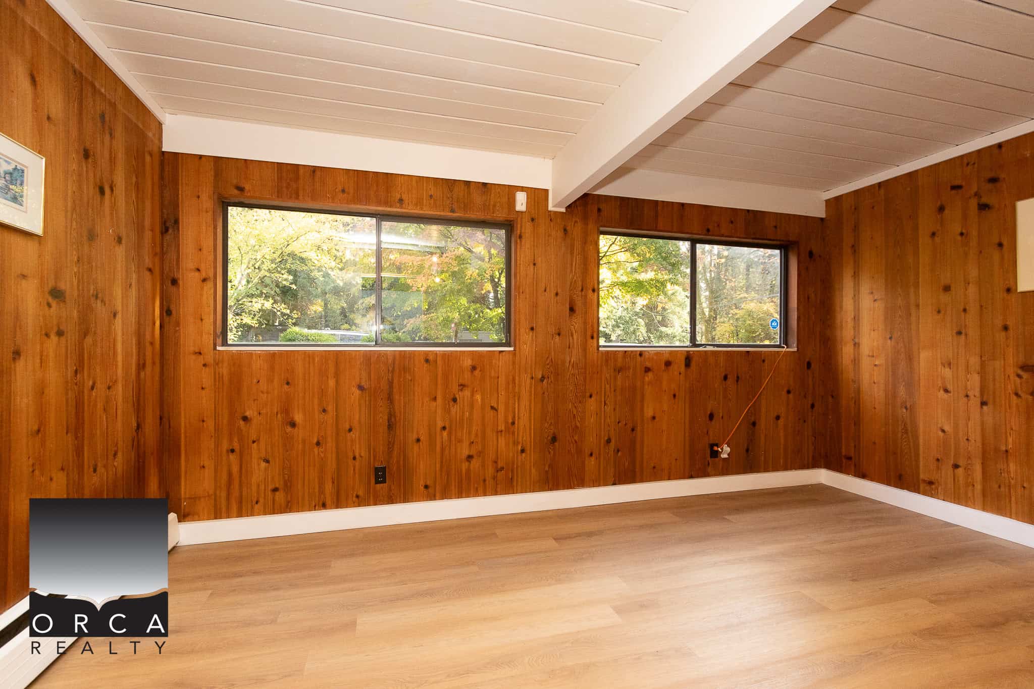 Wooden interior room with large windows and natural light, ideal for Vancouver BC real estate and come see this cozy home for sale or rent in the area SEO keywords.