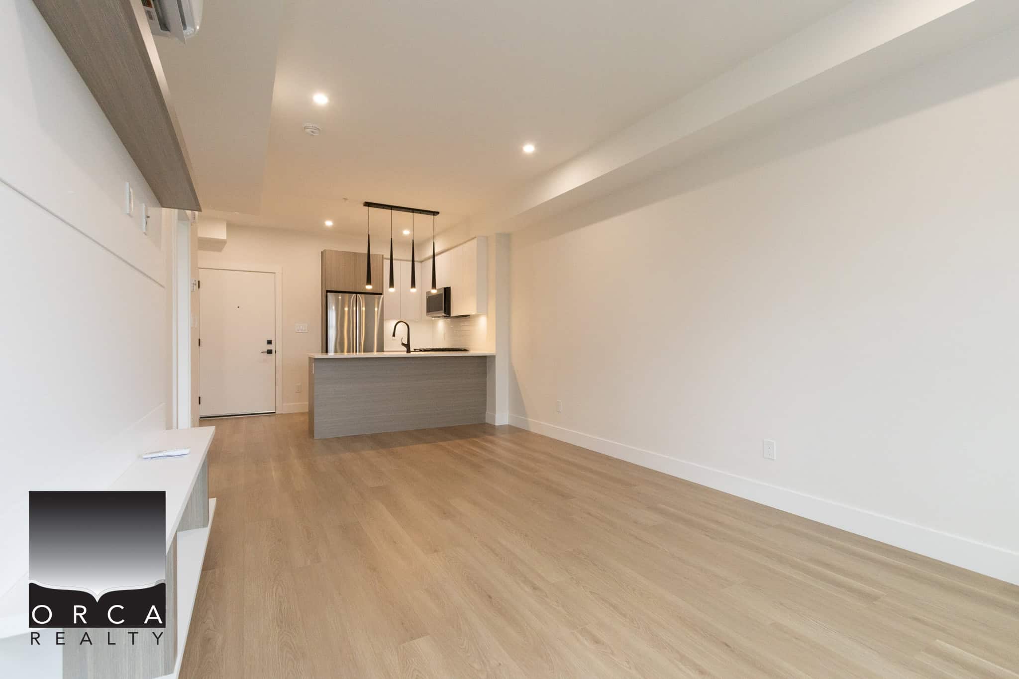 Bright modern open-concept living space with a contemporary kitchen, ideal for Vancouver-area real estate listings.