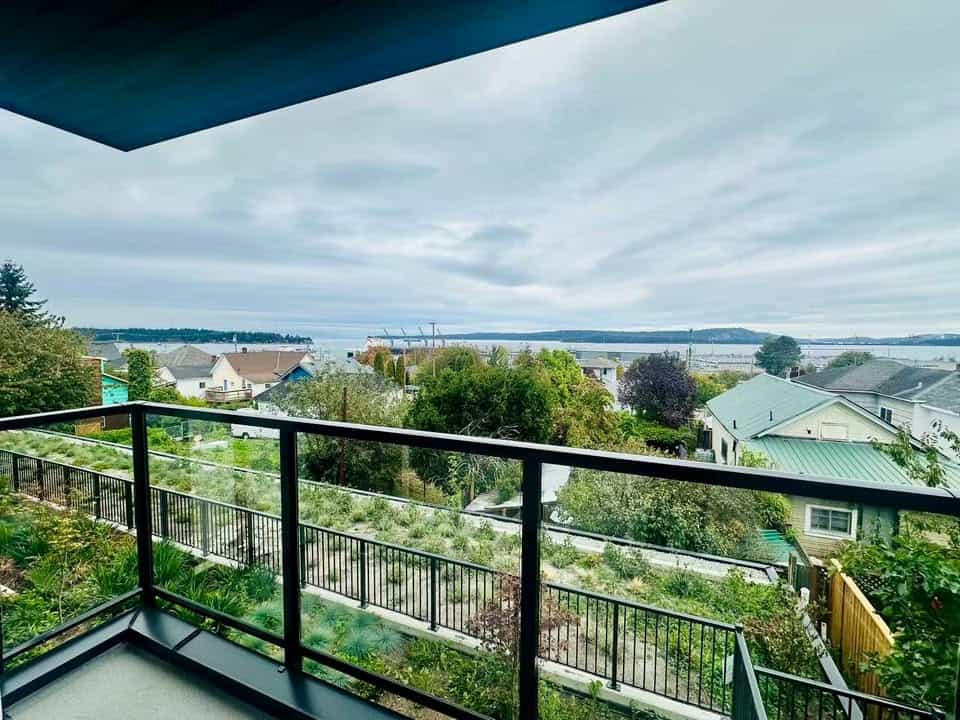 Beautiful waterfront view from a balcony in Victoria, British Columbia, showcasing scenic ocean and cityscape views, perfect for real estate in BC.