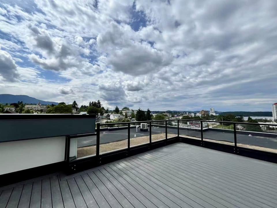 Spacious rooftop balcony with city and mountain views in Victoria, BC, showcasing modern living and outdoor space.