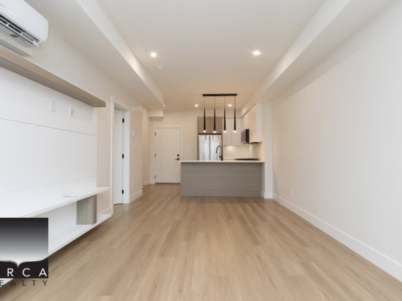 Modern open-concept kitchen and living space in a contemporary Vancouver apartment, featuring minimalist design, hardwood flooring, and stainless steel appliances, perfect for luxury urban living.