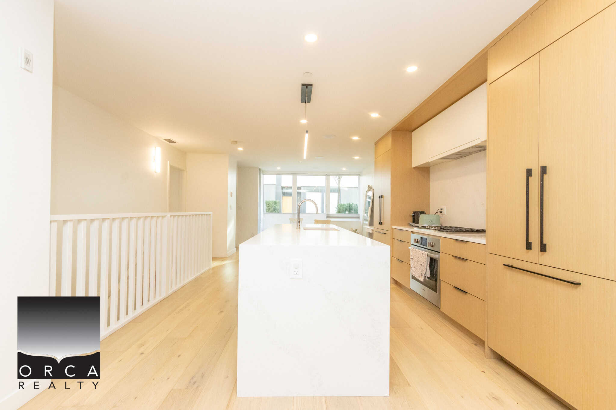 Bright and spacious kitchen in North Vancouver featuring sleek cabinetry, stainless steel appliances, and a large island perfect for cooking and entertaining.