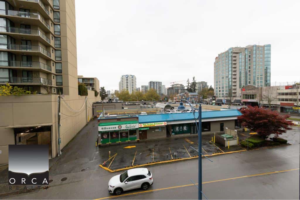 Modern downtown Vancouver cityscape with mixed-use buildings and commercial storefronts.