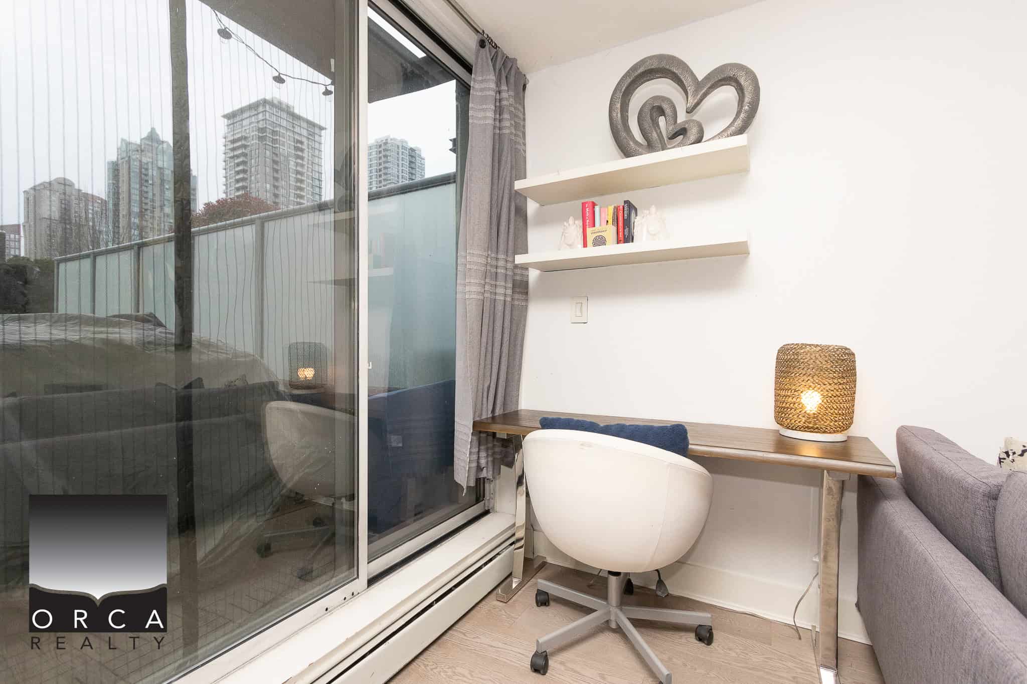Cozy apartment workspace with city skyline view, perfect for remote work or relaxation, in a modern Vancouver condo near downtown, showcasing stylish decor and functional design.