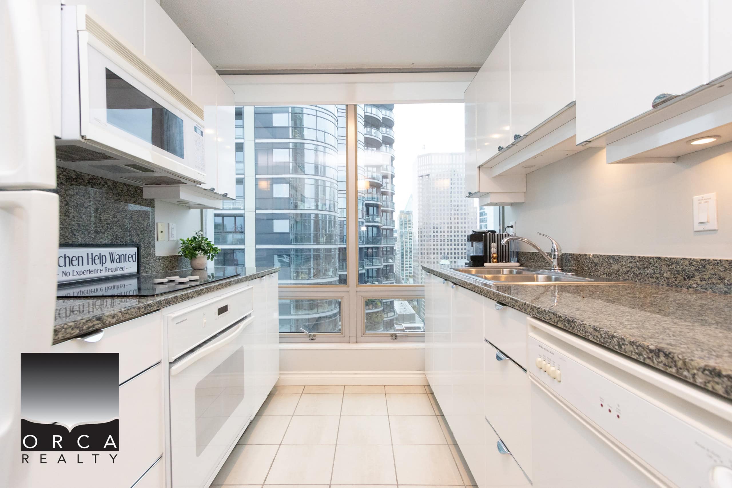 IMG_1726 Bright modern kitchen with city views, white cabinets, granite countertops, stainless steel appliances, ideal for Toronto real estate buyers and investors.