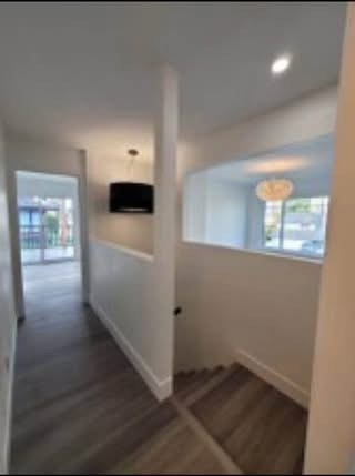 Bright modern interior of a residential property with a staircase and large windows providing natural light, showcasing Orca Realty Inc.'s expertise in Vancouver real estate.