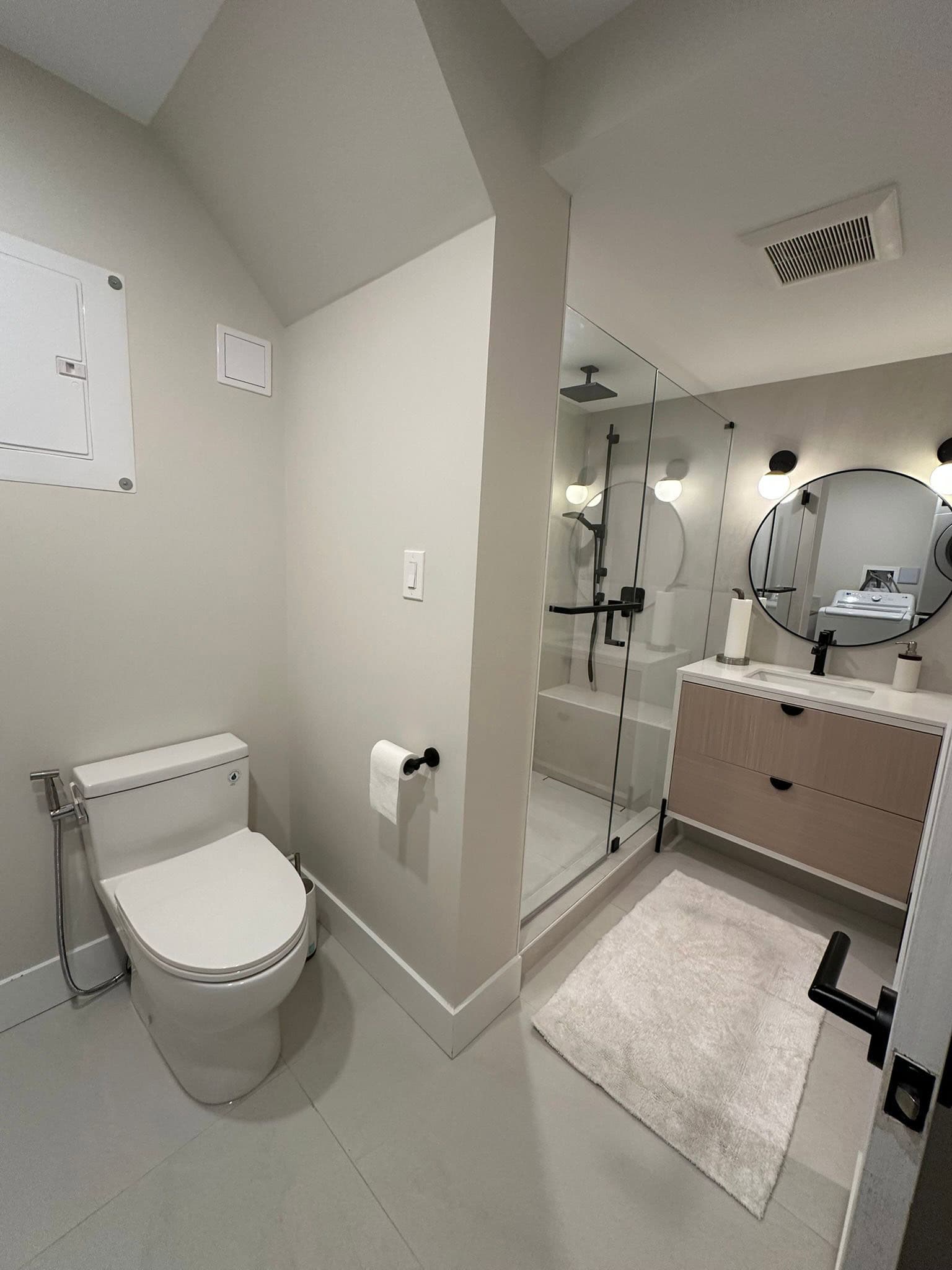 Modern minimalist bathroom with walk-in shower, sleek vanity, and contemporary fixtures. Perfect for luxury condominiums and modern homes in Vancouver, BC.