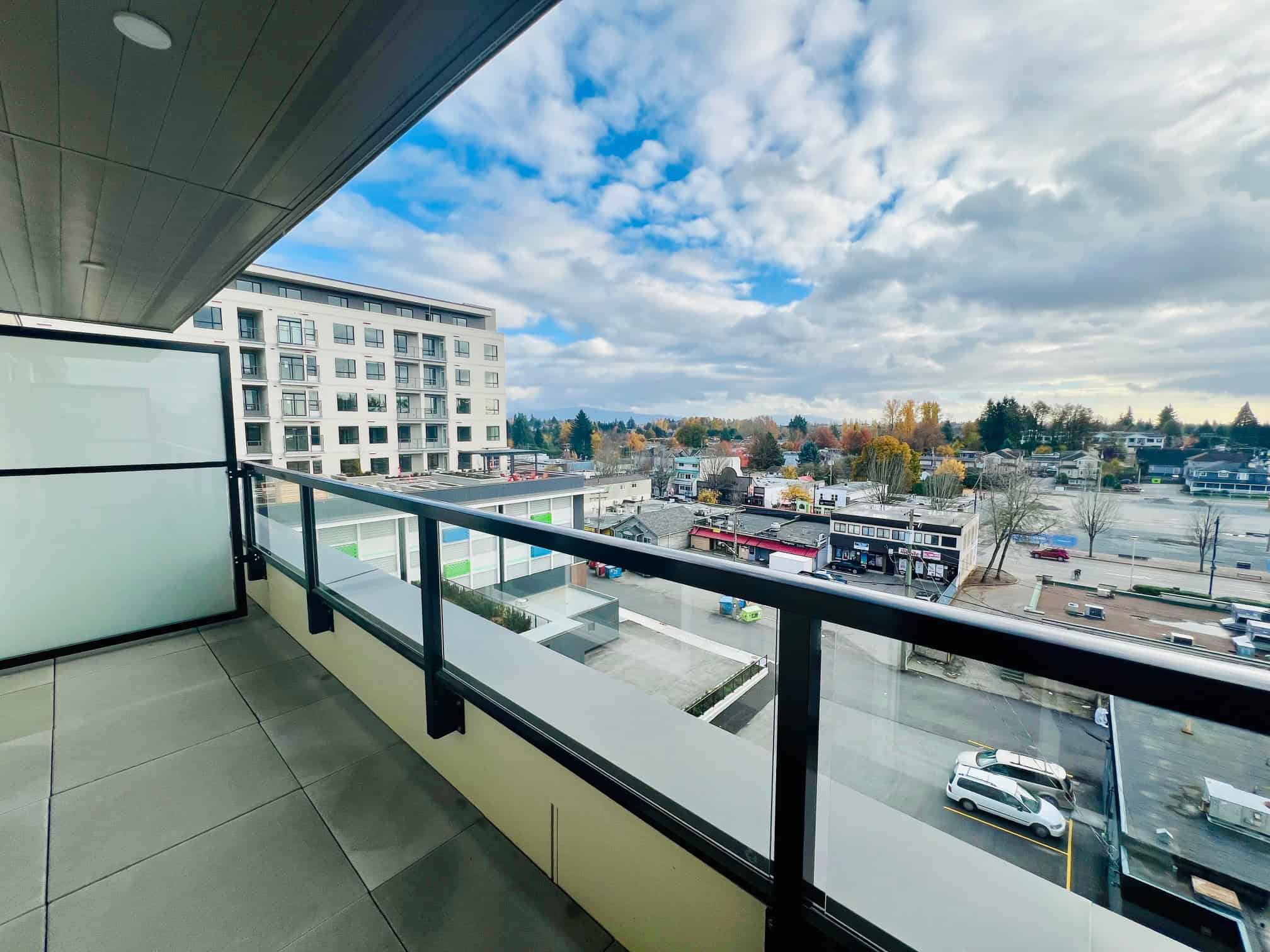 IMG_5611 Modern downtown Vancouver apartment balcony with cityscape view and modern high-rise buildings in the background.